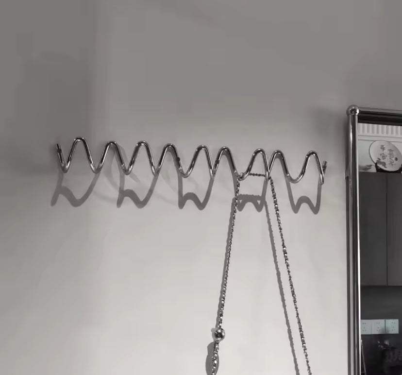 2 Squiggle coat hooks hung on wall together