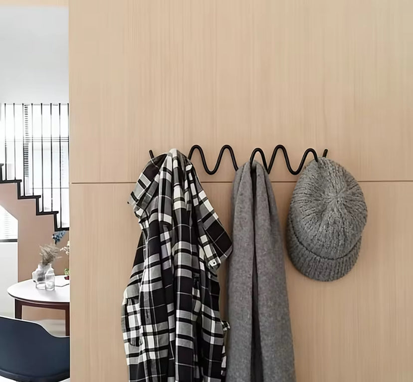 Coat hook rack with shirt, hat and scarf.