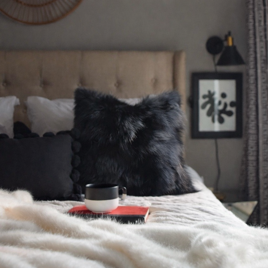 Cozy bedroom with black accents and Real Fox Fur Pillow in Black Color on bed