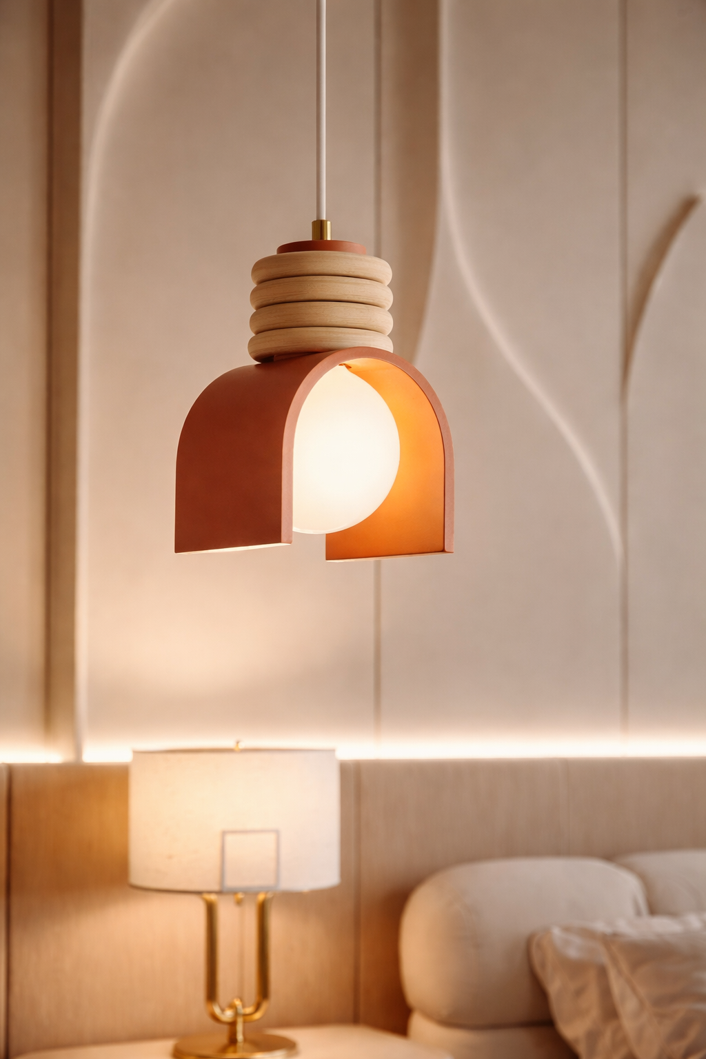 Modern pendant light fixture in a bedroom setting with neutral tones
