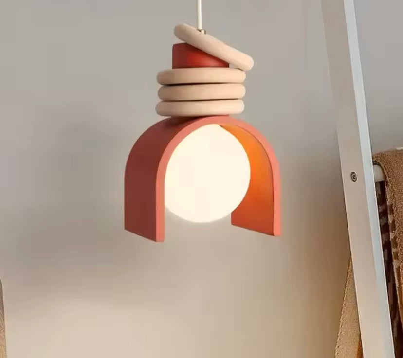 Modern pendant light is the Sol Arc pendant lamp in clay ember
