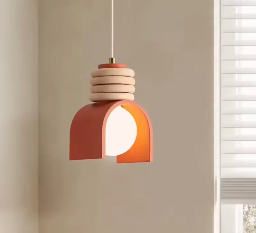 Modern pendant light with wooden accents is the Sol Arc pendant lamp in clay ember