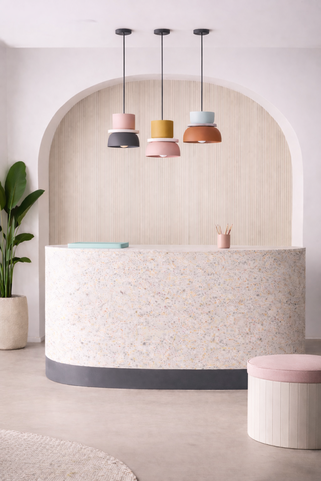 Modern reception desk with modal colourful pendant lighting in a minimalistic office setting.