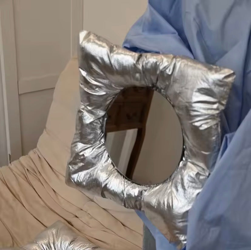 Person holding a Silver Mirror pillow