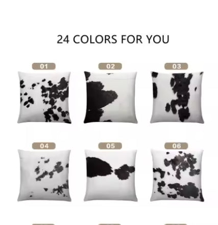 Real cow hide pillows with black and white patterns on a white background
