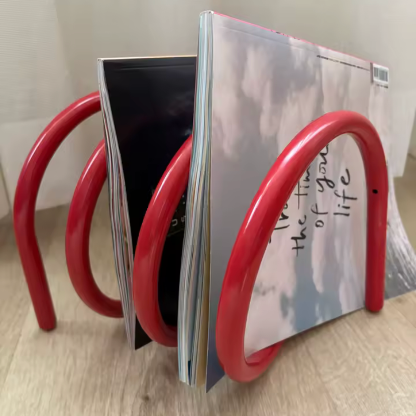 Ripple rack a unique modern colourful book rack and bookend for home decor and style in red with magazines on it