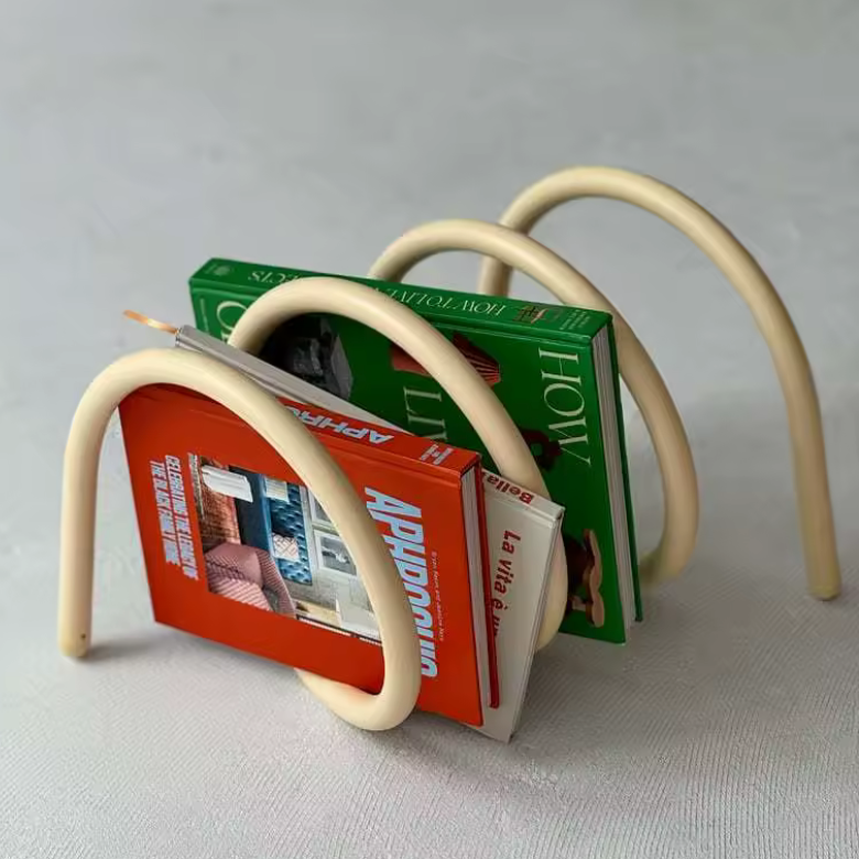 Ripple rack a unique modern colourful book rack and bookend for interior design and style in clay with books on it on the floor